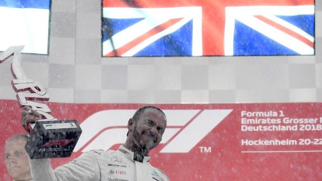 Mercedes driver Lewis Hamilton of Britain celebrates on the podium after winning the German Formula One Grand Prix at the Hockenheimring racetrack in Hockenheim.(AP)