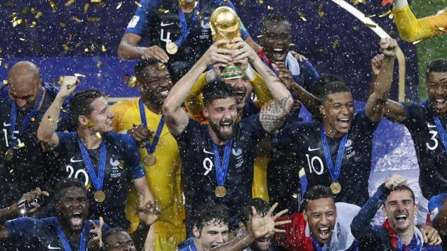 France's Olivier Giroud holds up the trophy as he celebrates with teammates at the end of the final match against Croatia.(AP)