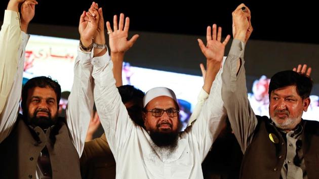 Hafiz Muhammad Saeed (C), chief of the Islamic charity organisation Jamaat-ud-Dawa (JuD), joins hands with Saeed Ahmed Gujar (R) nominated candidate of political party, Milli Muslim League (MML), as he attend a campaign rally, ahead of general elections in Islamabad, Pakistan July 21, 2018. (Reuters File Photo) Hafiz Muhammad Saeed (C), chief of the Islamic charity organisation Jamaat-ud-Dawa (JuD), joins hands with Saeed Ahmed Gujar (R) nominated candidate of political party, Milli Muslim League (MML), as he attend a campaign rally, ahead of general elections in Islamabad, Pakistan July 21, 2018. (Reuters File Photo)