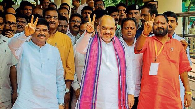 (From L-R) Union petroleum and natural gas minister Dharmendra Pradhan, BJP president Amit Shah and Odisha BJP state chief Basanta Panda in Bhubaneswar in July.(PTI File)