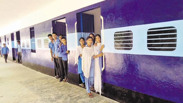 Students hang out of their classrooms at a government high school, which has been painted like a train, at Wara Bhai Ka village in Faridkot district. (HT Photo) Students hang out of their classrooms at a government high school, which has been painted like a train, at Wara Bhai Ka village in Faridkot district. (HT Photo)