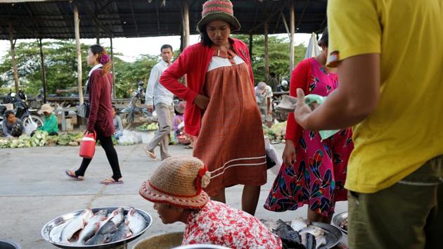 Touch buys food at a market outside the factory. Like many Cambodians, she has known no other leader but Hun Sen. “He is the only person who has ruled the country and I don’t know why,” she added. (Ann Wang / REUTERS) Touch buys food at a market outside the factory. Like many Cambodians, she has known no other leader but Hun Sen. “He is the only person who has ruled the country and I don’t know why,” she added. (Ann Wang / REUTERS)