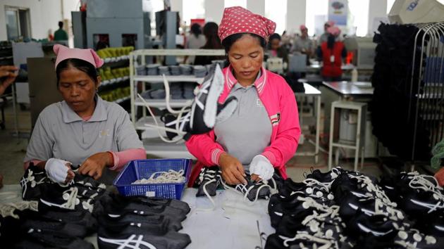 Women work on the production line at Complete Honour Footwear Industrial. Hun Sen, who has ruled the country for more than 30 years, is trying to ensure victory after two close elections in 2013 and 2017, by handing out cash inducements and a series of punishing measures against the opposition. His government has targeted opposition politicians, civil society groups and independent media ahead of the poll, which he appears set to win easily. (Ann Wang / REUTERS) Women work on the production line at Complete Honour Footwear Industrial. Hun Sen, who has ruled the country for more than 30 years, is trying to ensure victory after two close elections in 2013 and 2017, by handing out cash inducements and a series of punishing measures against the opposition. His government has targeted opposition politicians, civil society groups and independent media ahead of the poll, which he appears set to win easily. (Ann Wang / REUTERS)