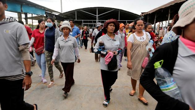 Workers arrive early morning for their shift at the factory. Hun Sen has also been a fixture at campaign rallies with garment workers - promising them more benefits and handing cash envelopes to pregnant employees. (Ann Wang / REUTERS) Workers arrive early morning for their shift at the factory. Hun Sen has also been a fixture at campaign rallies with garment workers - promising them more benefits and handing cash envelopes to pregnant employees. (Ann Wang / REUTERS)
