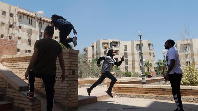 Mohamed Omran, coach at the PKE watches his students during a training session. Founded in France in the 1980s as the Art du Deplacement and later taking its name from the French word ‘parcours’ (course or route), Parkour involves running, climbing and jumping acrobatically around buildings and over terrain. (Amr Abdallah Dalsh / REUTERS)