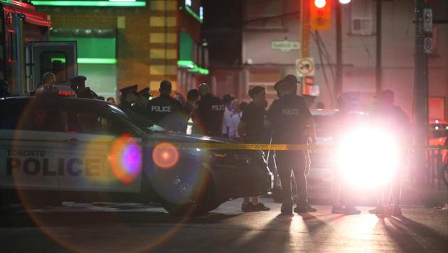 Police officers attend the scene of a mass shooting in Toronto, Canada on July 22. (REUTERS)