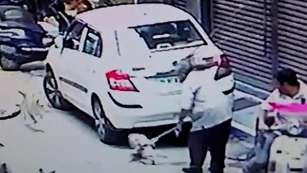 CCTV footage from the neighbourhood shows a man dragging a dog with a chain around its neck. CCTV footage from the neighbourhood shows a man dragging a dog with a chain around its neck.