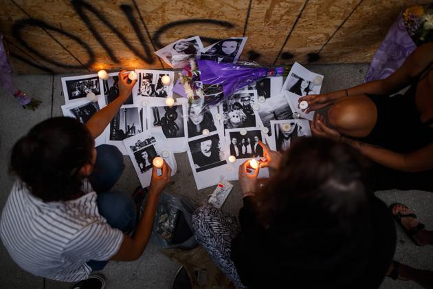 Friends of 18-year-old shooting victim Reese Fallon leave candles on pictures of Fallon at a makeshift memorial in remembrance of the victims of the shooting on Sunday evening, on Danforth Avenue in Toronto on July 23.(AP Photo) Friends of 18-year-old shooting victim Reese Fallon leave candles on pictures of Fallon at a makeshift memorial in remembrance of the victims of the shooting on Sunday evening, on Danforth Avenue in Toronto on July 23.(AP Photo)