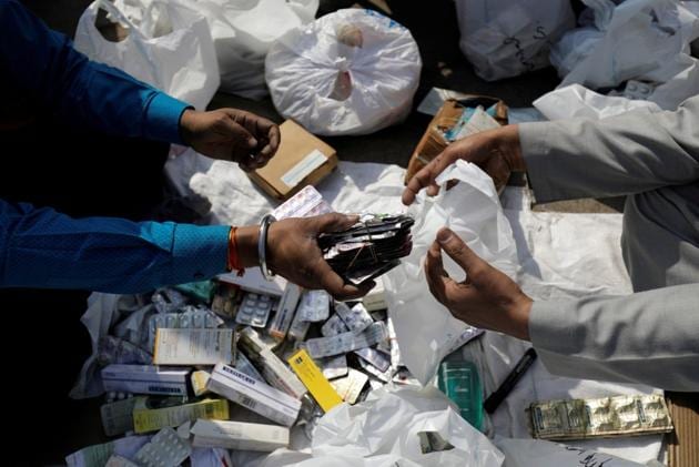 People segregate expired medicines outside a chemist store in New Delhi on February 2.(REUTERS) People segregate expired medicines outside a chemist store in New Delhi on February 2.(REUTERS)