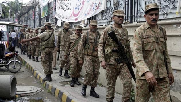 Soldiers arrive at a polling station in Lahore on Tuesday amid rising allegations of military inference. (AP Photo) Soldiers arrive at a polling station in Lahore on Tuesday amid rising allegations of military inference. (AP Photo)