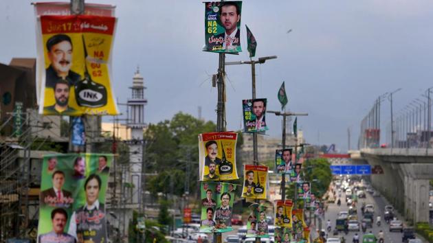 Banners of election candidates from political parties are displayed on poles on a highway in Rawalpindi, Pakistan, Tuesday, July 24.(AP Photo)