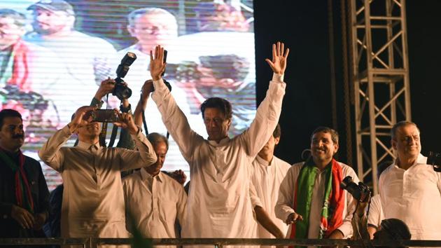 Pakistani cricket star-turned-politician and head of the Pakistan Tehreek-e-Insaf (PTI) Imran Khan (C) gestures as he arrives to deliver a speech during a campaign meeting ahead of the general election in Lahore on July 23, 2018. (AFP Photo) Pakistani cricket star-turned-politician and head of the Pakistan Tehreek-e-Insaf (PTI) Imran Khan (C) gestures as he arrives to deliver a speech during a campaign meeting ahead of the general election in Lahore on July 23, 2018. (AFP Photo)