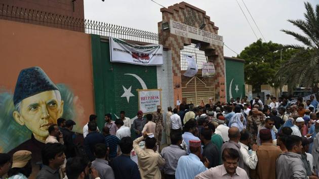 Pakistani election officials wait outside a distribution center to collect ballot boxes and voting materials in Karachi on July 24, 2018. (AFP Photo) Pakistani election officials wait outside a distribution center to collect ballot boxes and voting materials in Karachi on July 24, 2018. (AFP Photo)