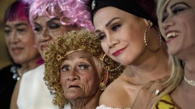 Al Enriquez (3L), 82, sheds his threadbare street vendor clothes like dead skin and develops a voguish, winking air once he slips into a gauzy gown and wig of tight blond curls. He is one of the stars of a beauty pageant for elderly and poor gay men in Manila, Philippines. Not a rowdy, hooting drag show for tourists, it is part of the decades-long work of a collective of men to take care of their own. They call themselves the Golden Gays and they mean it. (Noel Celis / AFP) Al Enriquez (3L), 82, sheds his threadbare street vendor clothes like dead skin and develops a voguish, winking air once he slips into a gauzy gown and wig of tight blond curls. He is one of the stars of a beauty pageant for elderly and poor gay men in Manila, Philippines. Not a rowdy, hooting drag show for tourists, it is part of the decades-long work of a collective of men to take care of their own. They call themselves the Golden Gays and they mean it. (Noel Celis / AFP)