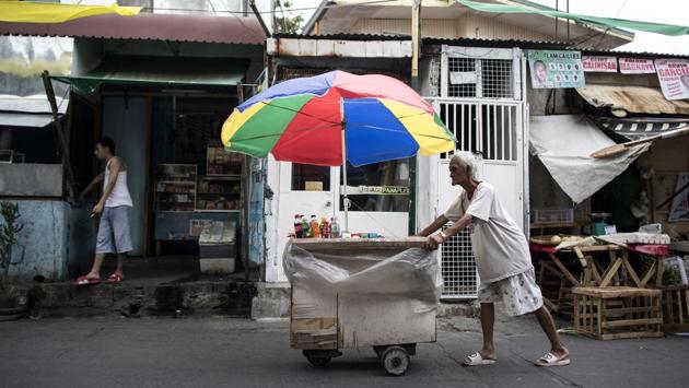 Enriquez, also known as ‘Carmen Dela Rue’, pushes his wooden cart on a street in Manila. The Philippines has a reputation of openness toward homosexuality, but experts say legal protections are lacking and the nation’s weak social safety net especially fails older gay people. Most of the 48 members of Golden Gays are in their 60s and are among the millions of Filipinos who survive on less than five dollars per day. (Noel Celis / AFP) Enriquez, also known as ‘Carmen Dela Rue’, pushes his wooden cart on a street in Manila. The Philippines has a reputation of openness toward homosexuality, but experts say legal protections are lacking and the nation’s weak social safety net especially fails older gay people. Most of the 48 members of Golden Gays are in their 60s and are among the millions of Filipinos who survive on less than five dollars per day. (Noel Celis / AFP)