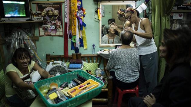Ramasamy (3R), a long-time Golden Gay, was rejected by his parents once they learned of his sexuality. And then he made his way to Manila, where the Golden Gays became his family and a refuge from the real life in which he makes about two dollars a day for a 15-hour shift as a dishwasher. The group has served as family that many of its members don’t have. (Noel Celis / AFP) Ramasamy (3R), a long-time Golden Gay, was rejected by his parents once they learned of his sexuality. And then he made his way to Manila, where the Golden Gays became his family and a refuge from the real life in which he makes about two dollars a day for a 15-hour shift as a dishwasher. The group has served as family that many of its members don’t have. (Noel Celis / AFP)