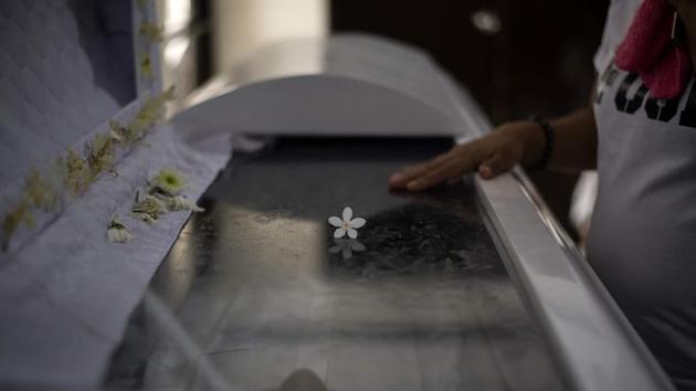 A relative of late Fernandez attends his wake at a funeral house. Anthropologist Michael Tan said life is a struggle for elderly Filipinos in general because social safety nets like pensions and health-care are quite weak compared to those in more developed nations. Not having children to turn to makes it even more difficult for gay men. (Noel Celis / AFP) A relative of late Fernandez attends his wake at a funeral house. Anthropologist Michael Tan said life is a struggle for elderly Filipinos in general because social safety nets like pensions and health-care are quite weak compared to those in more developed nations. Not having children to turn to makes it even more difficult for gay men. (Noel Celis / AFP)