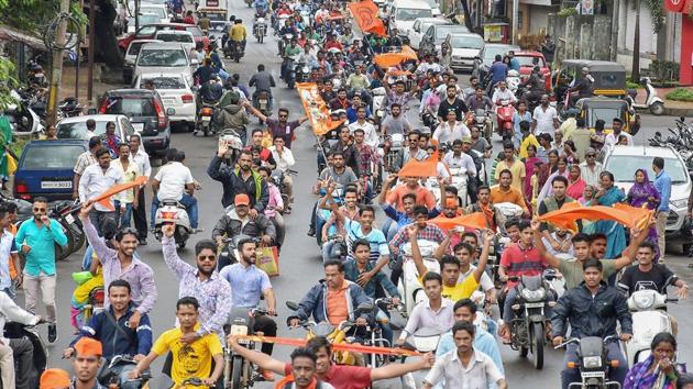 Maratha community members take part in a bike protest rally against the government demanding reservation in Kolhapur on Tuesday.(PTI Photo)