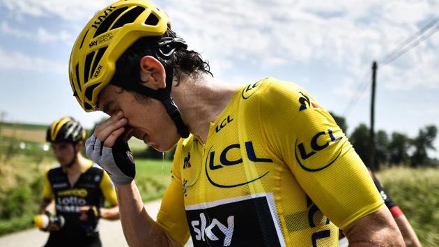 Geraint Thomas cleans his eyes after tear gas was used during a farmers' protest who attempted to block the stage's route at the Tour de France. (AFP) Geraint Thomas cleans his eyes after tear gas was used during a farmers' protest who attempted to block the stage's route at the Tour de France. (AFP)