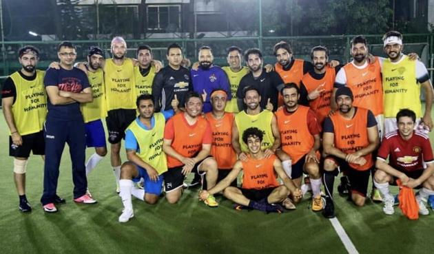 MS Dhoni poses with players after the practice match.