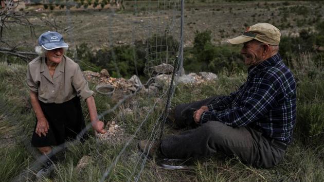 Colomer jokes with his wife as he sets up a fence around their field in the village. “We have always lived like this. When it’s cold, we make a fire. We sleep under blankets. You are here, you have chickens, rabbits, the land, and you manage,” said Colomers wife Sancho. (Susana Vera / REUTERS) Colomer jokes with his wife as he sets up a fence around their field in the village. “We have always lived like this. When it’s cold, we make a fire. We sleep under blankets. You are here, you have chickens, rabbits, the land, and you manage,” said Colomers wife Sancho. (Susana Vera / REUTERS)