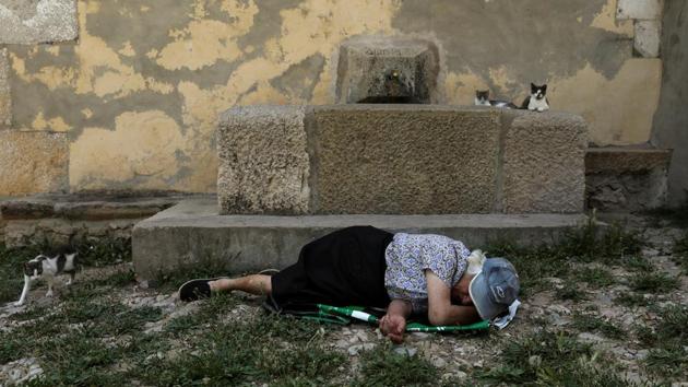 Sancho dozes off on the ground in the only square in the village. (Susana Vera / REUTERS) Sancho dozes off on the ground in the only square in the village. (Susana Vera / REUTERS)