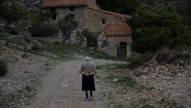 Sinforosa Sancho, 85, takes a walk in the empty village of La Estrella, Spain. For more than 30 years, Sinforosa and her husband Juan Martin Colomer have lived alone in the village in Spain's eastern highlands that once had more than 200 inhabitants. "Everyone has gone, we are the fools who have stayed," said Sinforosa. (Susana Vera / REUTERS) Sinforosa Sancho, 85, takes a walk in the empty village of La Estrella, Spain. For more than 30 years, Sinforosa and her husband Juan Martin Colomer have lived alone in the village in Spain's eastern highlands that once had more than 200 inhabitants. "Everyone has gone, we are the fools who have stayed," said Sinforosa. (Susana Vera / REUTERS)
