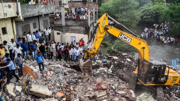 Fire brigade officials and locals try to rescue animals after rescuing 8 people who were trapped after the wall of a residential building collapsed in Keshawnagar, Mundhwa in Pune, on Saturday. (Sanket Wankhade/HT PHOTO) Fire brigade officials and locals try to rescue animals after rescuing 8 people who were trapped after the wall of a residential building collapsed in Keshawnagar, Mundhwa in Pune, on Saturday. (Sanket Wankhade/HT PHOTO)