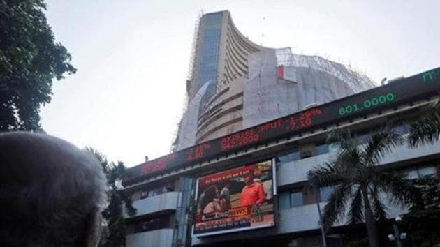 People watch a large screen displaying India's benchmark share index on the facade of the Bombay Stock Exchange (BSE) building in Mumbai. (Reuters File Photo) People watch a large screen displaying India's benchmark share index on the facade of the Bombay Stock Exchange (BSE) building in Mumbai. (Reuters File Photo)