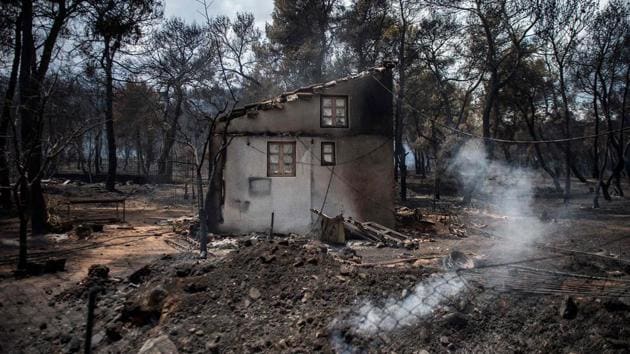 A burnt house in the village of Neos Voutzas. Dozens were overtaken by the flames in their homes, on foot or in their cars and the death toll could surpass that from the blazes that hit Greece’s southern island of Evia in 2007 in which 77 people perished. (Angelos Tzortzinis / AFP) A burnt house in the village of Neos Voutzas. Dozens were overtaken by the flames in their homes, on foot or in their cars and the death toll could surpass that from the blazes that hit Greece’s southern island of Evia in 2007 in which 77 people perished. (Angelos Tzortzinis / AFP)