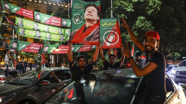 Supporters of Imran Khan, head of the Pakistan Tehreek-e-Insaf (PTI), also known as Movement for Justice, hold signs while celebrating on a street in Lahore, Pakistan, on Wednesday, July 25, 2018. Pakistan's Imran Khan took an early lead in a tightly-fought election. (Bloomberg) Supporters of Imran Khan, head of the Pakistan Tehreek-e-Insaf (PTI), also known as Movement for Justice, hold signs while celebrating on a street in Lahore, Pakistan, on Wednesday, July 25, 2018. Pakistan's Imran Khan took an early lead in a tightly-fought election. (Bloomberg)