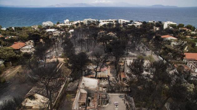 An aerial view shows burnt houses following a wildfire in the village of Mati, near Athens, . (AFP Photo) An aerial view shows burnt houses following a wildfire in the village of Mati, near Athens, . (AFP Photo)
