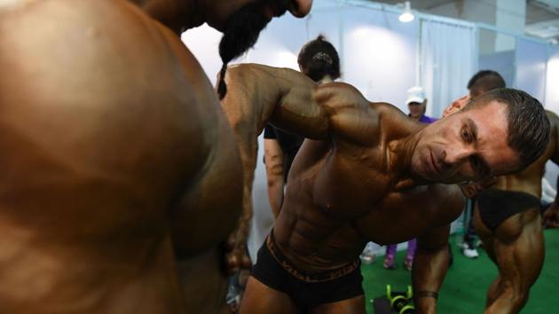 Bodybuilders prepare backstage for the men's bodybuilding competition at the International Health, Sports and Fitness Festival in New Delhi on July 22, 2018. (Sajjad Hussain / AFP) Bodybuilders prepare backstage for the men's bodybuilding competition at the International Health, Sports and Fitness Festival in New Delhi on July 22, 2018. (Sajjad Hussain / AFP)