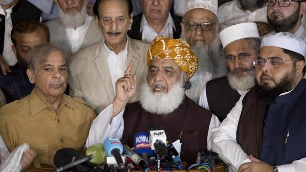 Maulana Fazlur Rehman, center, head of Pakistani religious parties alliance surrounds by Pakistani politicians addresses a news conference after the All Parties Conference (APC) in Islamabad, Pakistan, Friday, July 27, 2018.(AP)