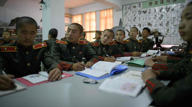 The 1,000 shaven-headed boys wear a military-style uniform said to have been designed by the senior Kim’s wife Kang Pan Sok, a red line down their trousers symbolising their devotion to the cause of revolution. After graduating they will all go into the military, a key part of the nuclear-armed North Korean state - Kim Jong Il espoused a “military first” philosophy. (Ed Jones / AFP) The 1,000 shaven-headed boys wear a military-style uniform said to have been designed by the senior Kim’s wife Kang Pan Sok, a red line down their trousers symbolising their devotion to the cause of revolution. After graduating they will all go into the military, a key part of the nuclear-armed North Korean state - Kim Jong Il espoused a “military first” philosophy. (Ed Jones / AFP)
