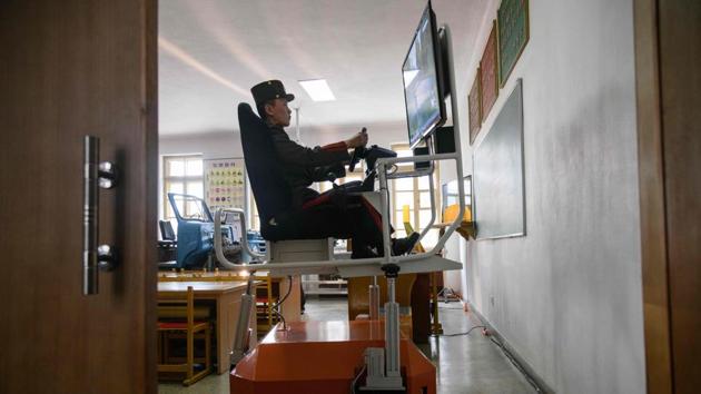 A student practices driving a military vehicle on a simulator at the Mangyongdae Revolutionary School. When this school was founded in the early days of the Democratic People’s Republic, it copied the Soviet Union’s Suvorov military schools for veterans’ orphans. (Ed Jones / AFP) A student practices driving a military vehicle on a simulator at the Mangyongdae Revolutionary School. When this school was founded in the early days of the Democratic People’s Republic, it copied the Soviet Union’s Suvorov military schools for veterans’ orphans. (Ed Jones / AFP)