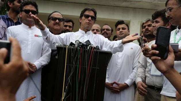 Cricket star-turned-politician Imran Khan, chairman of Pakistan Tehreek-e-Insaf (PTI), speaks to members of media after casting his vote at a polling station during the general election in Islamabad, Pakistan, July 25, 2018.(Reuters)