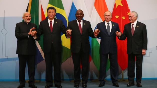 (LtoR) Prime Minister Narendra Modi, China's President Xi Jinping, South Africa's President Cyril Ramaphosa, Russia's President Vladimir Putin and Brazil's President Michel Temer pose for a group picture during the 10th BRICS (acronym for the grouping of the world's leading emerging economies, namely Brazil, Russia, India, China and South Africa) summit on July 26, 2018 at the Sandton Convention Centre in Johannesburg, South Africa. (Mike Hutchings / AFP) (LtoR) Prime Minister Narendra Modi, China's President Xi Jinping, South Africa's President Cyril Ramaphosa, Russia's President Vladimir Putin and Brazil's President Michel Temer pose for a group picture during the 10th BRICS (acronym for the grouping of the world's leading emerging economies, namely Brazil, Russia, India, China and South Africa) summit on July 26, 2018 at the Sandton Convention Centre in Johannesburg, South Africa. (Mike Hutchings / AFP)