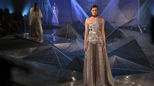 From asymmetrical maxis, midis and minis with giant ruffles, dramatic frilled-out handkerchief hem to tops, dresses, gowns, sarees that had one shoulder artfully askew, Aggarwal’s collection had it all.  (Amal KS/HT Photo) 