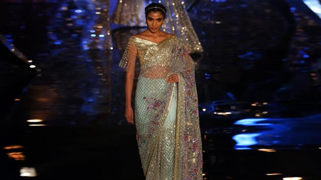 This pastel shade saree with net detailing above screams elegance. We love the bead detailing on the blouse, a trend that’s bound to have a long shelf life. (Amal KS/HT Photo) This pastel shade saree with net detailing above screams elegance. We love the bead detailing on the blouse, a trend that’s bound to have a long shelf life. (Amal KS/HT Photo)