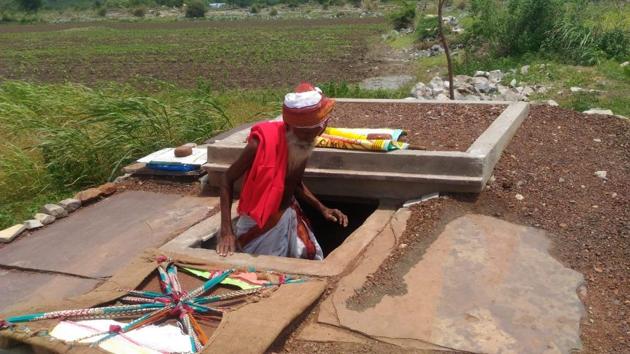 Tathireddy Lachi Reddy demonstrates how he planned to bury himself alive in the concrete pit he had constructed at Gannavaram village on Thursday. (HT Photo) Tathireddy Lachi Reddy demonstrates how he planned to bury himself alive in the concrete pit he had constructed at Gannavaram village on Thursday. (HT Photo)