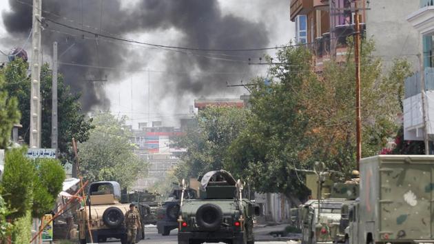 Plumes of black smoke could be seen rising from the centre and gunfire could be heard from inside. (Reuters) Plumes of black smoke could be seen rising from the centre and gunfire could be heard from inside. (Reuters)