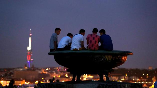 Clouds obscure the view for people sitting on a statue to see the lunar eclipse in Prague, Czech Republic. The fullest eclipse was visible from Europe, Russia, Africa, the Middle East, and much of Asia and Australia though clouds blocked out the moon in some places. (David W Cerny / REUTERS)