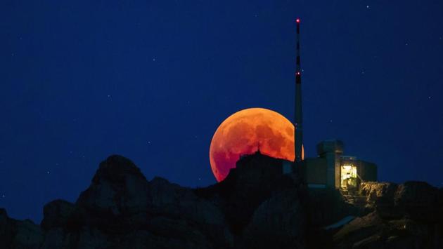 The moon turns red during the total lunar eclipse, behind the Saentis in Luzern, Switzerland. The Bible contains references to the moon turning into blood and some ultra-Orthodox Jews consider lunar eclipses ominous and a cause for moral contemplation. (Christian Merz / Keystone via AP)