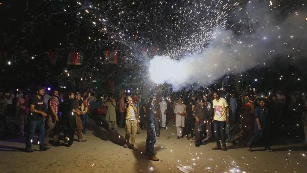 A supporter of Imran Khan, chief of the Tehreek-e-Insaf party, releases fireworks to celebrate projected unofficial results announced by television channels indicating their candidates' success in the parliamentary elections in Islamabad on July 26.(AP Photo)