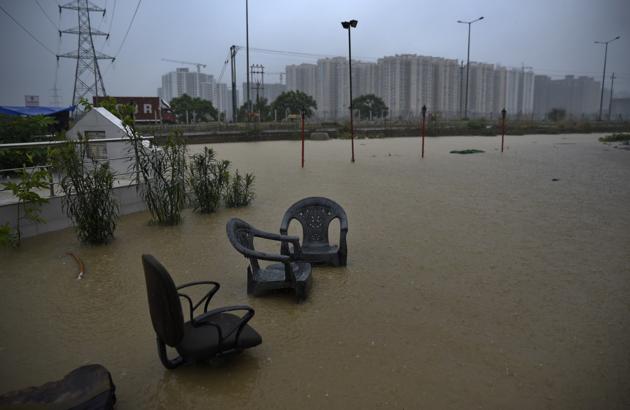Chairs stand submerged in rainwater outside a roadside shop during heavy monsoon rainfall in Greater Noida. The water level of the Yamuna in Delhi breached the warning level of 204m after Haryana released more water. An alert has been sounded by the Delhi government after the water level crossed the danger mark, an official said. (R S Iyer / AP) Chairs stand submerged in rainwater outside a roadside shop during heavy monsoon rainfall in Greater Noida. The water level of the Yamuna in Delhi breached the warning level of 204m after Haryana released more water. An alert has been sounded by the Delhi government after the water level crossed the danger mark, an official said. (R S Iyer / AP)