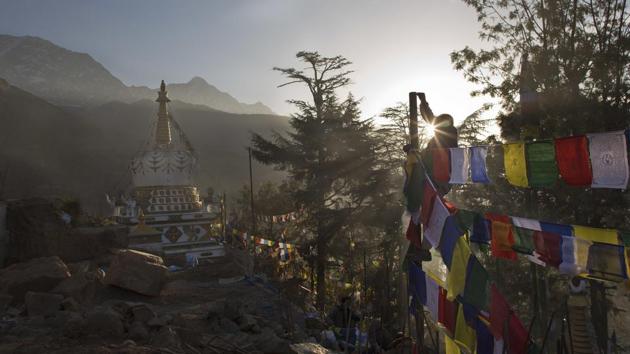 A man ties prayer flags called lungta (wind horse) on a high pole to mark the Tibetan New Year. (AP File Photo/Representative image) A man ties prayer flags called lungta (wind horse) on a high pole to mark the Tibetan New Year. (AP File Photo/Representative image)