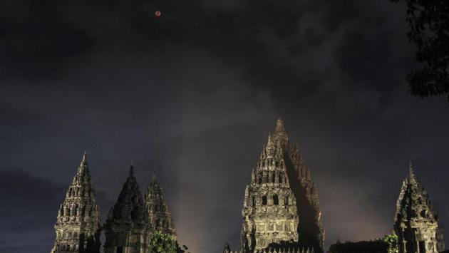 A blood moon is seen from the Prambanan temple in Yogyakarta, Indonesia. According to some Hindu beliefs, celestial bodies such as the sun and moon emit negative energy during an eclipse and so some temples in India were closed to minimize any disturbance. (Slamet Riyadi / AP)