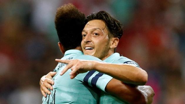 Arsenal's Mesut Ozil celebrates scoring their first goal with Pierre-Emerick Aubameyang.(REUTERS)