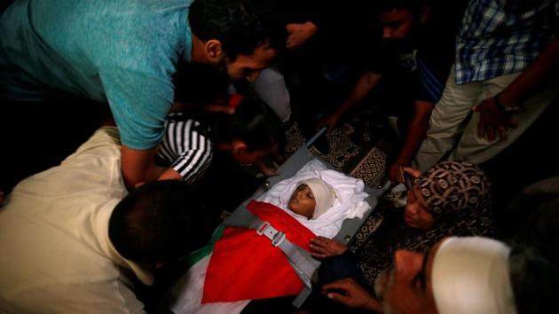 Mourners gather around the body of Palestinian boy Majdi al-Satari, who was killed by Israeli troops during a protest at the Israel-Gaza border, during his funeral in Rafah in the southern Gaza Strip July 28, 2018. (REUTERS) Mourners gather around the body of Palestinian boy Majdi al-Satari, who was killed by Israeli troops during a protest at the Israel-Gaza border, during his funeral in Rafah in the southern Gaza Strip July 28, 2018. (REUTERS)